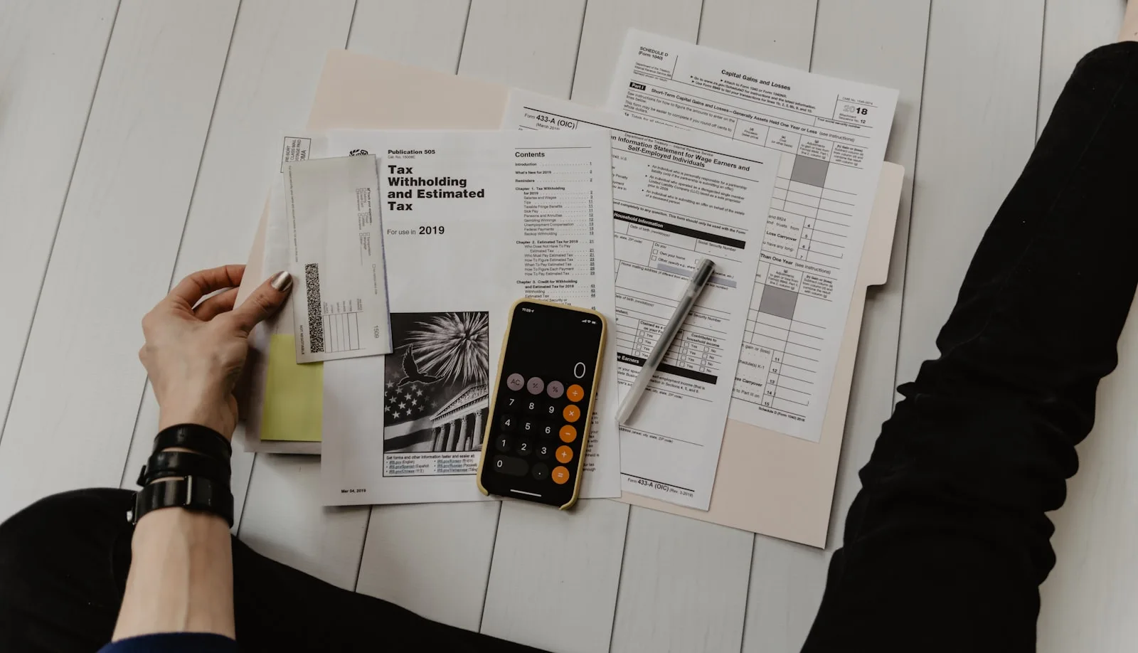 Person reviewing financial reports and documents for accurate investment calculation